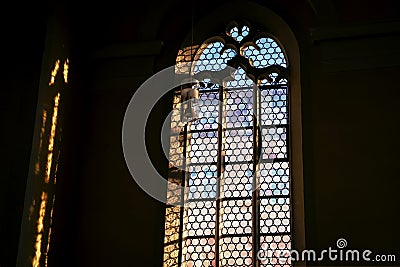 Beautiful window and a lamp in the german catholic church. Light and shadow Stock Photo