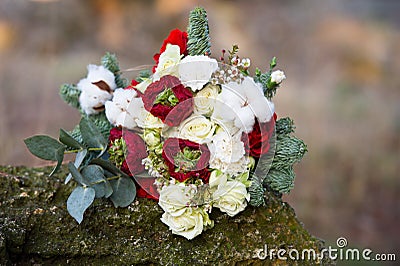 Beautiful winter bouquet of spruce, roses and cotton. The bride`s bouquet. Stock Photo