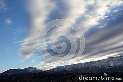 Beautiful winter day with blue skies and puffy in the snow covered mountains in Tucson Arizona Stock Photo