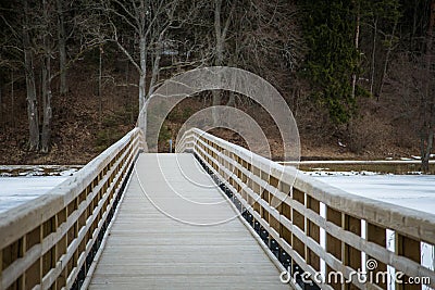 A beautiful winter landscape with a bridge over the frozen river Stock Photo