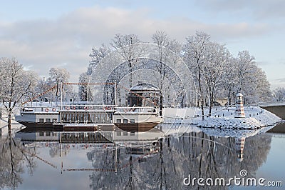 Beautiful winter landscape with cafeteria in shape of boat with nice reflection in water Stock Photo