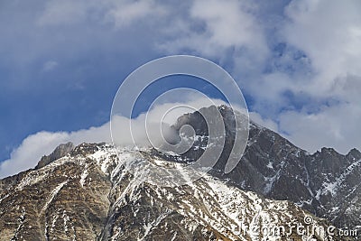 Beautiful winter mountains landscape on the sunrise. High snow covered mountains in the clouds. Georgia, Kazbegi. Stock Photo