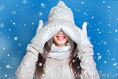 Beautiful winter portrait of young woman in the winter snowy scenery . Snowing winter beauty concept. Girl closes eyes with her ha Stock Photo