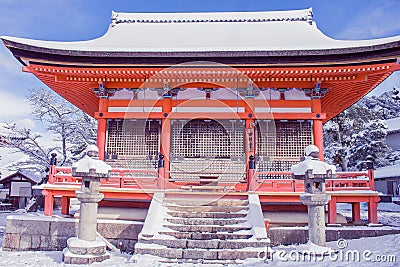 Beautiful winter seasonal of Red Pagoda at Kiyomizu-dera temple surrounded with trees covered white snow background at Kyoto. Stock Photo