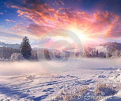 Beautiful winter sunrise in mountain village. Stock Photo