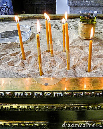 Beautiful wish candles burning in the church Stock Photo