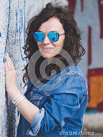 Beautiful woman against concrete wall Stock Photo