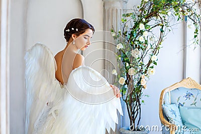 Beautiful woman with angel wings inspires beauty Stock Photo