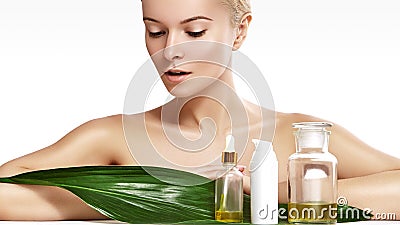 Beautiful woman applies organic cosmetic and oils for beauty. Spa and wellness. Clean skin, shiny hair. Healthcare Stock Photo