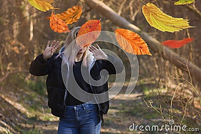 Beautiful woman in autumn landscape with trees in yellow orange red colors Stock Photo