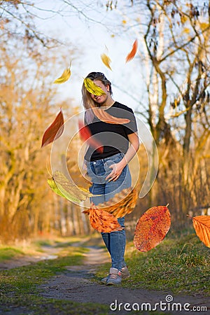 Beautiful woman in autumn landscape with trees in yellow orange red colors Stock Photo