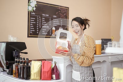 Beautiful woman bakery or coffee shop owner is smiling in her shop Stock Photo