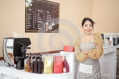 Beautiful woman bakery or coffee shop owner is smiling in her shop Stock Photo