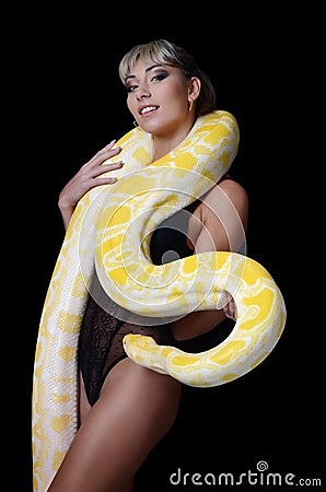 The beautiful woman with the big yellow snake Stock Photo