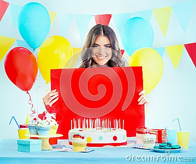 Beautiful woman with a birthday cake making silence gesture Stock Photo