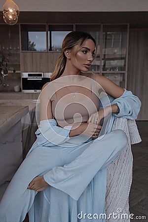 beautiful woman with blond hair in elegant cosy home clothes Stock Photo