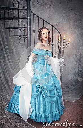 Beautiful woman in blue medieval dress with candelabrum Stock Photo