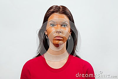 Beautiful woman with a clay or a mud mask on her face over white background Stock Photo