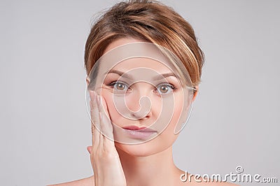 Beautiful woman with clean perfect skin touch own face. Stock Photo