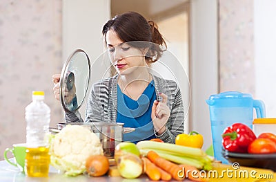 Beautiful woman cooking vegetarian lunch Stock Photo