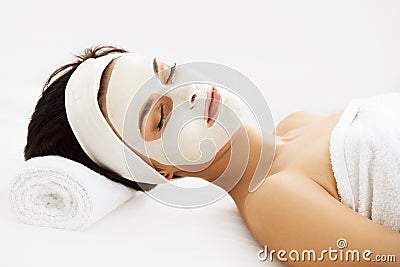 Beautiful Woman With Cosmetic Mask on Face. Girl Gets Treatment Stock Photo