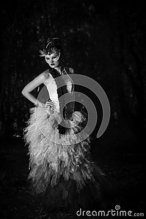 Beautiful woman in couture dress standing in a forest Stock Photo