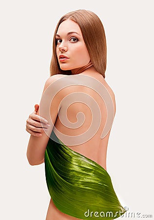 Beautiful woman covering with big leaf Stock Photo