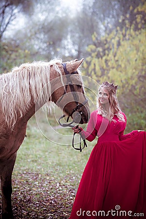 Beautiful woman in crown, blonde with horse. Princess in fairy tale. Stock Photo