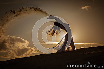 Beautiful woman dancing at gold sunset Stock Photo