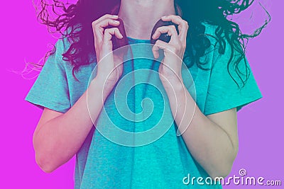 Beautiful woman dancing with headphones around her neck - blue and purple background Stock Photo