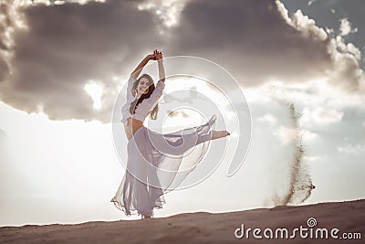 Beautiful woman dancing at sunrise Stock Photo