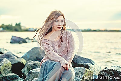 Beautiful woman dreaming. Pretty girl on ocean background Stock Photo