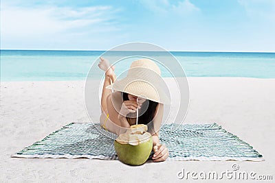 Beautiful woman drinks a coconut water Stock Photo