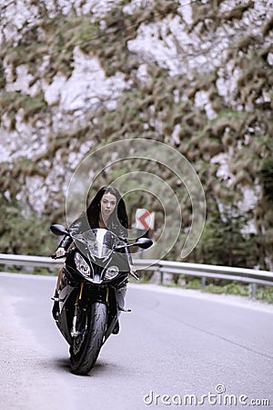 Beautiful woman driving a motorcycle Stock Photo