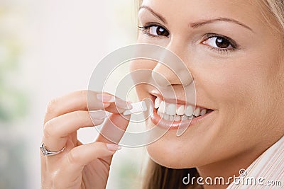 Beautiful woman eating chewing gum Stock Photo