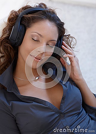 Beautiful woman enjoying music eyes closed Stock Photo