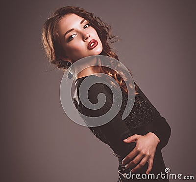 Beautiful woman with evening make-up in black dress Stock Photo