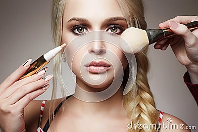 Make-up. apply cosmetics. model blonde girl Stock Photo