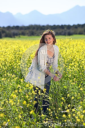 Beautiful woman in a field of golden rapeseed. Stock Photo