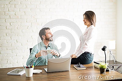 Beautiful woman flirting with a coworker Stock Photo