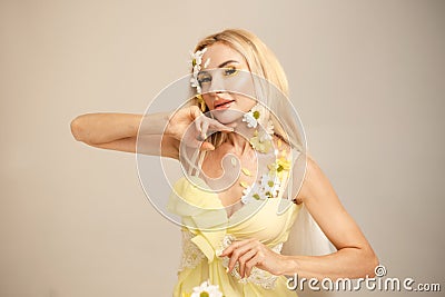 Beautiful woman with flowers and petals on her face. Beauty concept Stock Photo