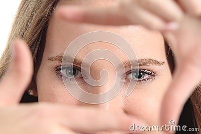 Beautiful woman framing her blue eyes with the fingers Stock Photo