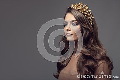 Beautiful woman in gold crown on her head. Stock Photo