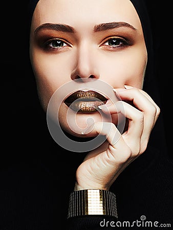 Beautiful woman,gold jewelry.face like a mask Stock Photo