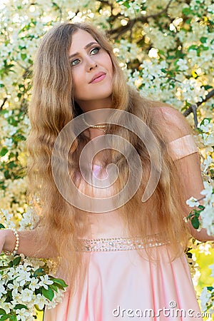 Beautiful woman with gorgeous hair in blooming garden Stock Photo