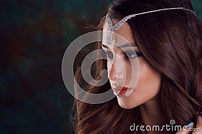 Beautiful woman in green indian sari and jewelry on colorful background Stock Photo