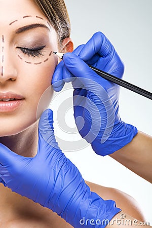 Beautiful woman half face photo plastic surgery, plastic surgeon hands Stock Photo