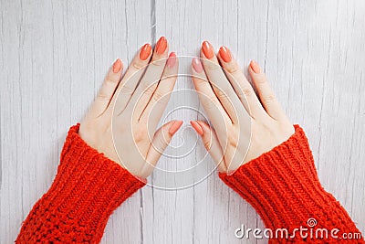 Beautiful woman hands with gently coral manicure on nails. Cream for hands and treatment. Hand skin care Stock Photo