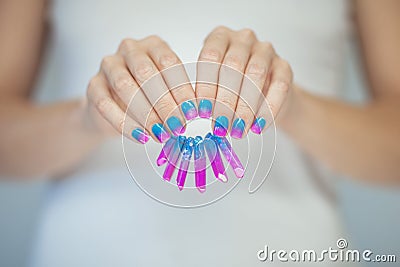 Beautiful woman hands with perfect violet pink and turquoise nail polish Stock Photo