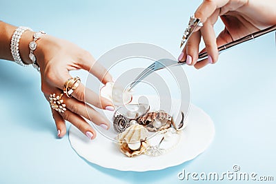 Beautiful woman hands with pink manicure holding plate with pearls and sea shells, luxury jewelry concept Stock Photo